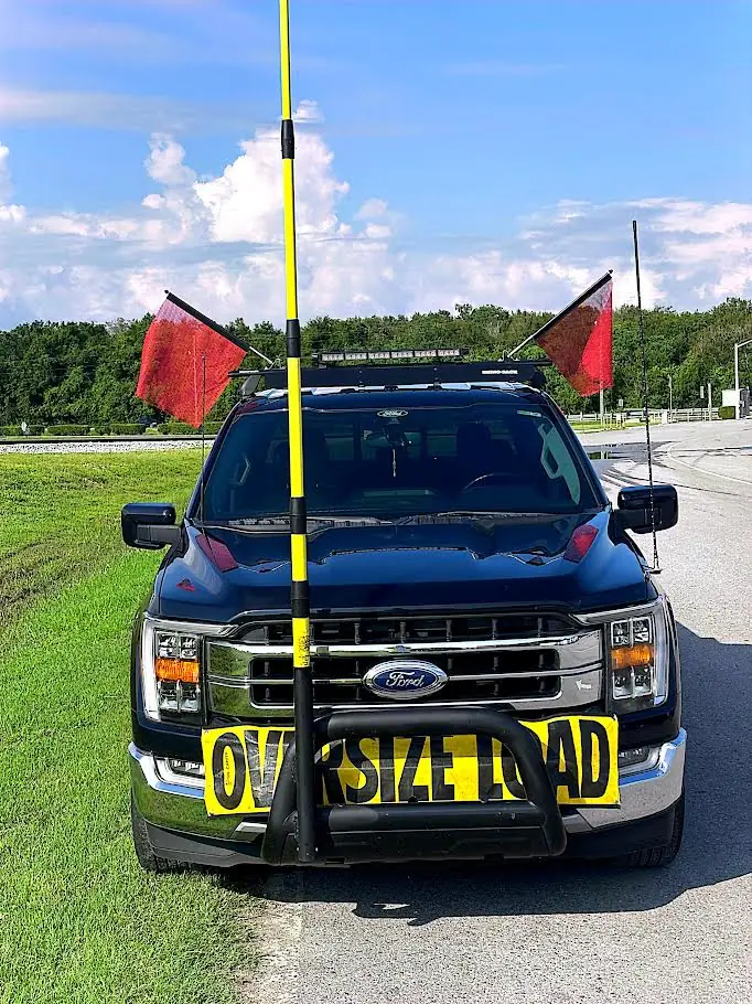 Front view of Austin's pilot escort truck with high pole and oversize-load banner