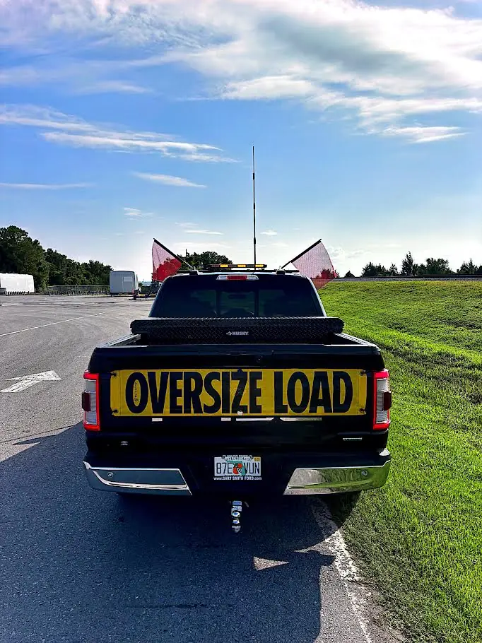 Rear view of Austin's pilot escort truck with oversize-load banner